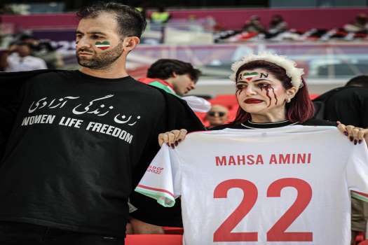 In opposition to Wales, Iran supporters sang and booed their own national song.